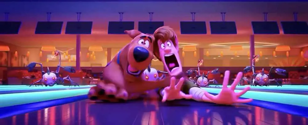 Scoob! Scooby-Doo and Shaggy sliding down a bowling alley