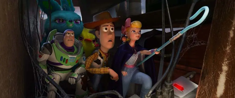 Toy Story 4 Woody, Bo Peep, Buzz Lightyear and the bunnies behind furniture