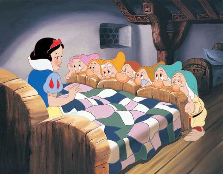 Snow White in bed naming the seven Dwarfs as they look over the foot of the bed