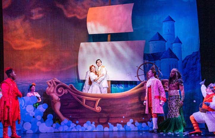 The Little Mermaid musical with cast singing on stage