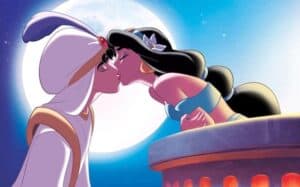 Aladdin kissing Princess Jasmine while she leans over her balcony
