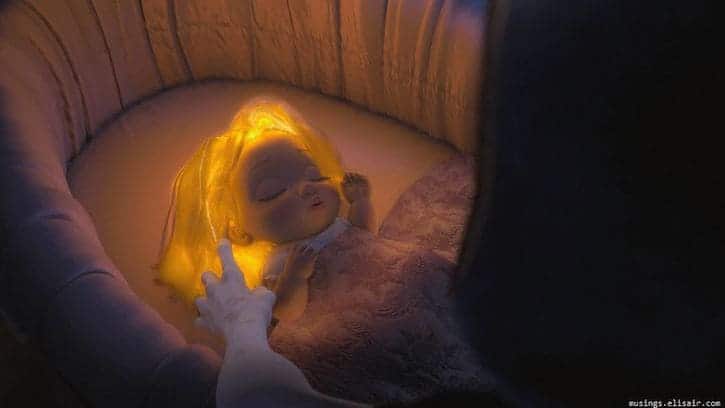Baby Rapunzel with magical glowing yellow hair laying in her crib