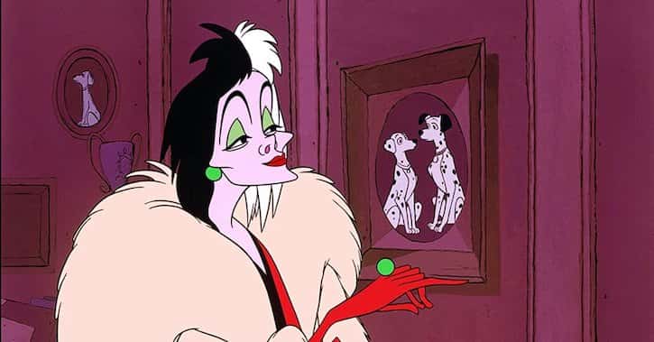 Cruella De Vil looking at a photo of Pongo and Perdita with bad intentions