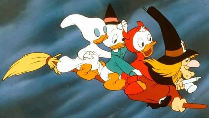 Huey Dewey and Louie riding on a broomstick with the witch Hazel