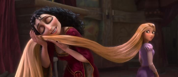 Mother Gothel rubbing Rapunzels hair on her cheek