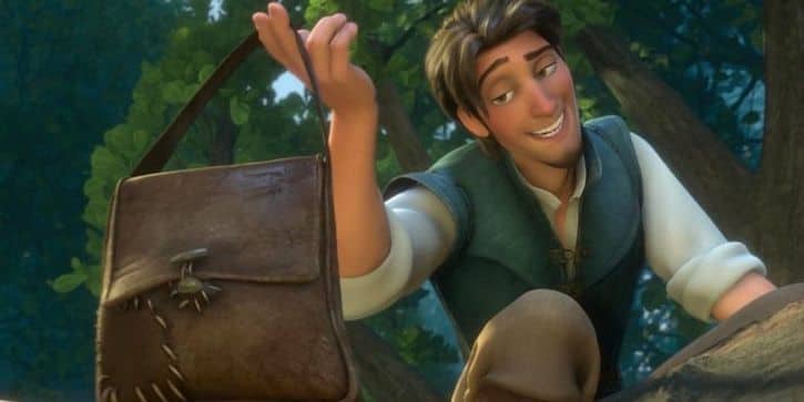 Prince Flynn Rider smiling and holding up a leather bag with a stolen crown inside