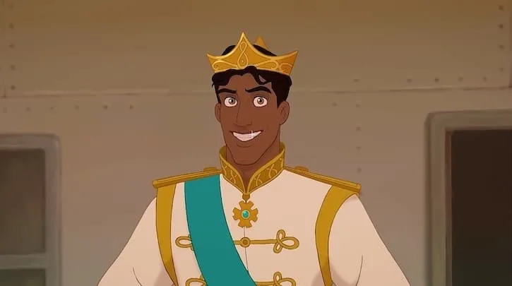 Prince Naveen wearing his royal suite, blue sash, and gold crown