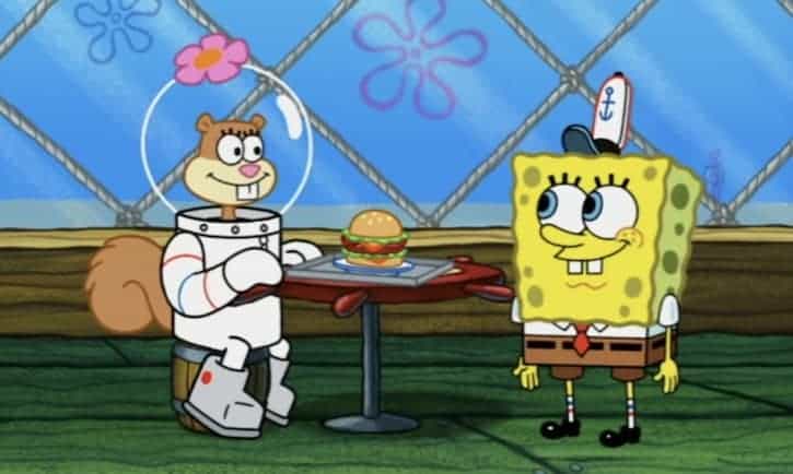 SpongeBob and Sandy Cheeks eating a burger at the Krusty Crab