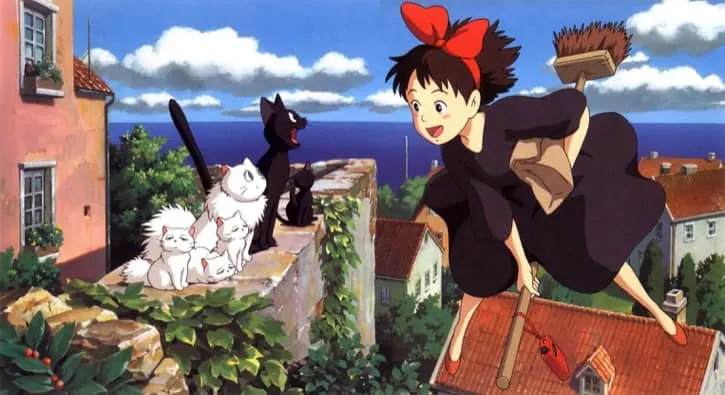 Kiki's Delivery Service with Kiki flying on a broom and looking at cats on a high ledge