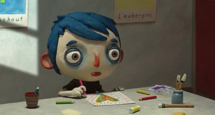 My Life as A Zucchini main character Courgette drawing pictures at a table