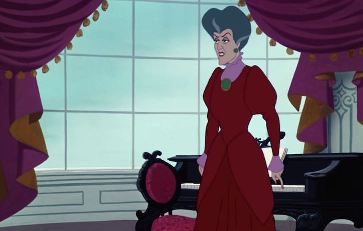 Lady Tremaine standing by a piano