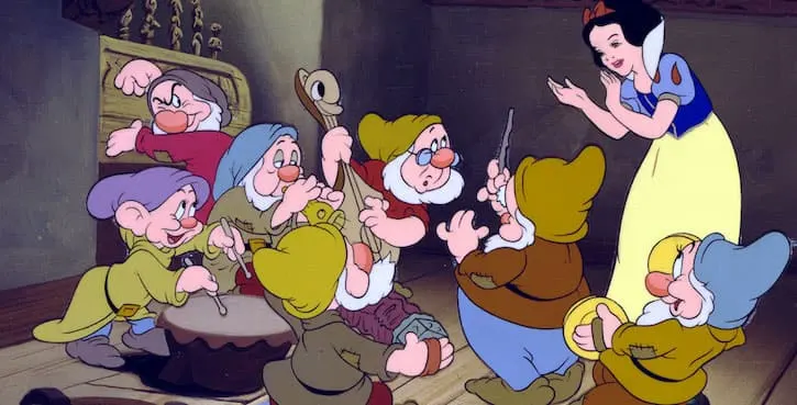 Snow White dancing and playing music with the seven dwarfs