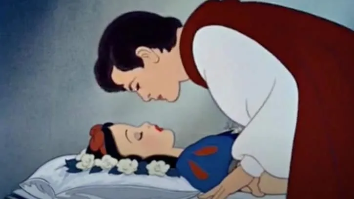 The Prince leaning in to kiss Snow White who is sleeping