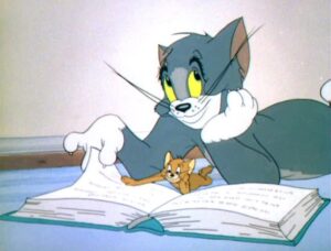 Tom and Jerry reading a book on the floor together