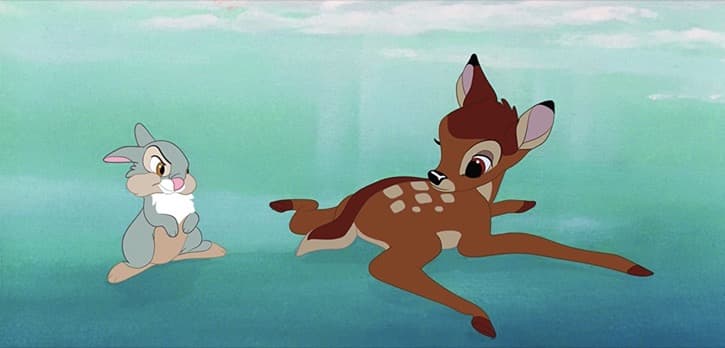 Bambi and Thumper on the ice with Bambi laying down with his arms spread wide after a fall