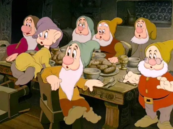 Dopey at the dinner table with the other dwarfs