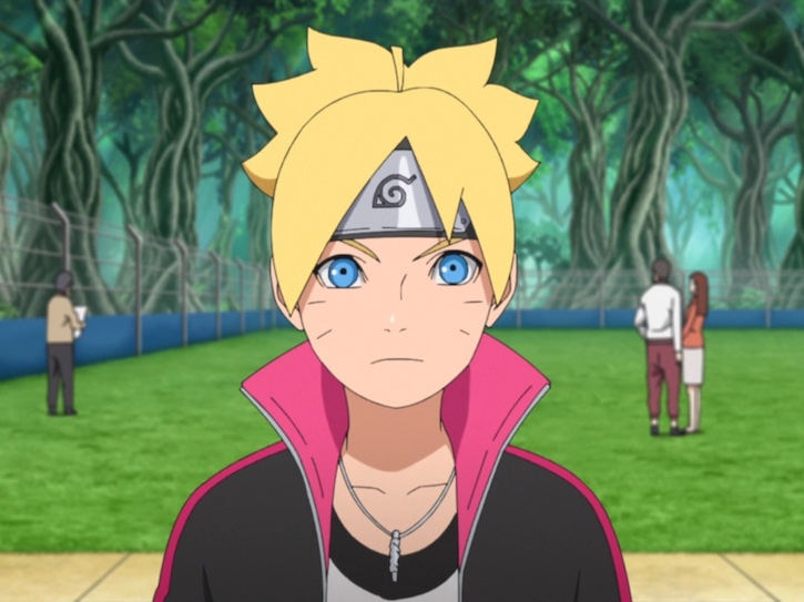Boruto at a park from the shoulders up as he faces the camera