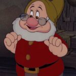 Doc Dwarf wearing a red tunic, brown hat, and glasses