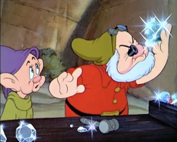 Doc dwarf closely inspecting a diamond