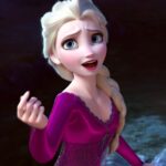 Elsa singing and facing the camera in a purple dress
