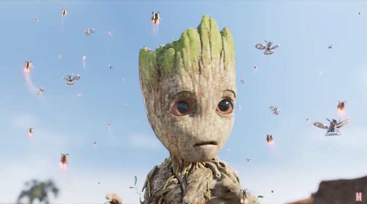 Groot being attacked by small flying blue creatures