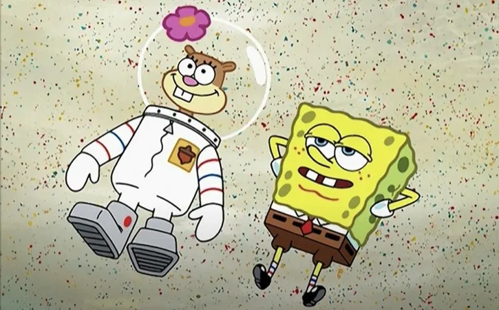 Sandy Cheeks and SpongeBob SquarePants laying in the sand watching the clouds