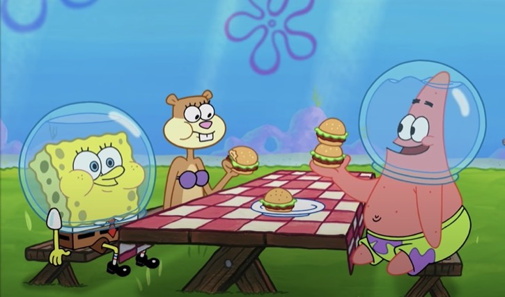 Sandy, SpongeBob, and Patrick eating hamburgers in Sandy's treedome