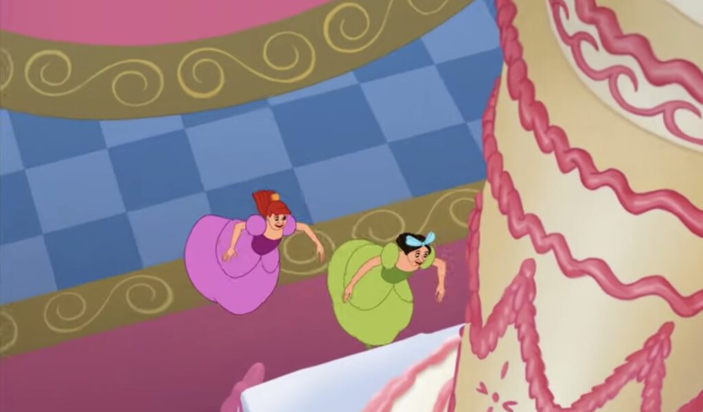 Drizella and Anastasia running towards a large cake
