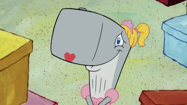 Pearl Krabs smiling and watching a boy band sing to her