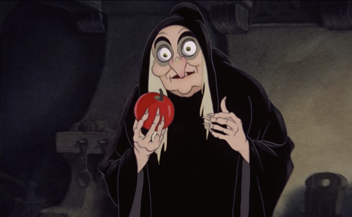 The Evil Queen in Snow White and the Seven Dwarfs disguised as and old witch with a red poisoned apple