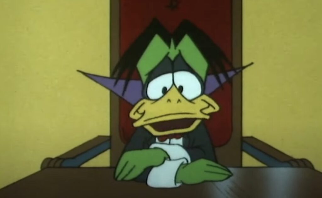 count duckula sitting at a long table